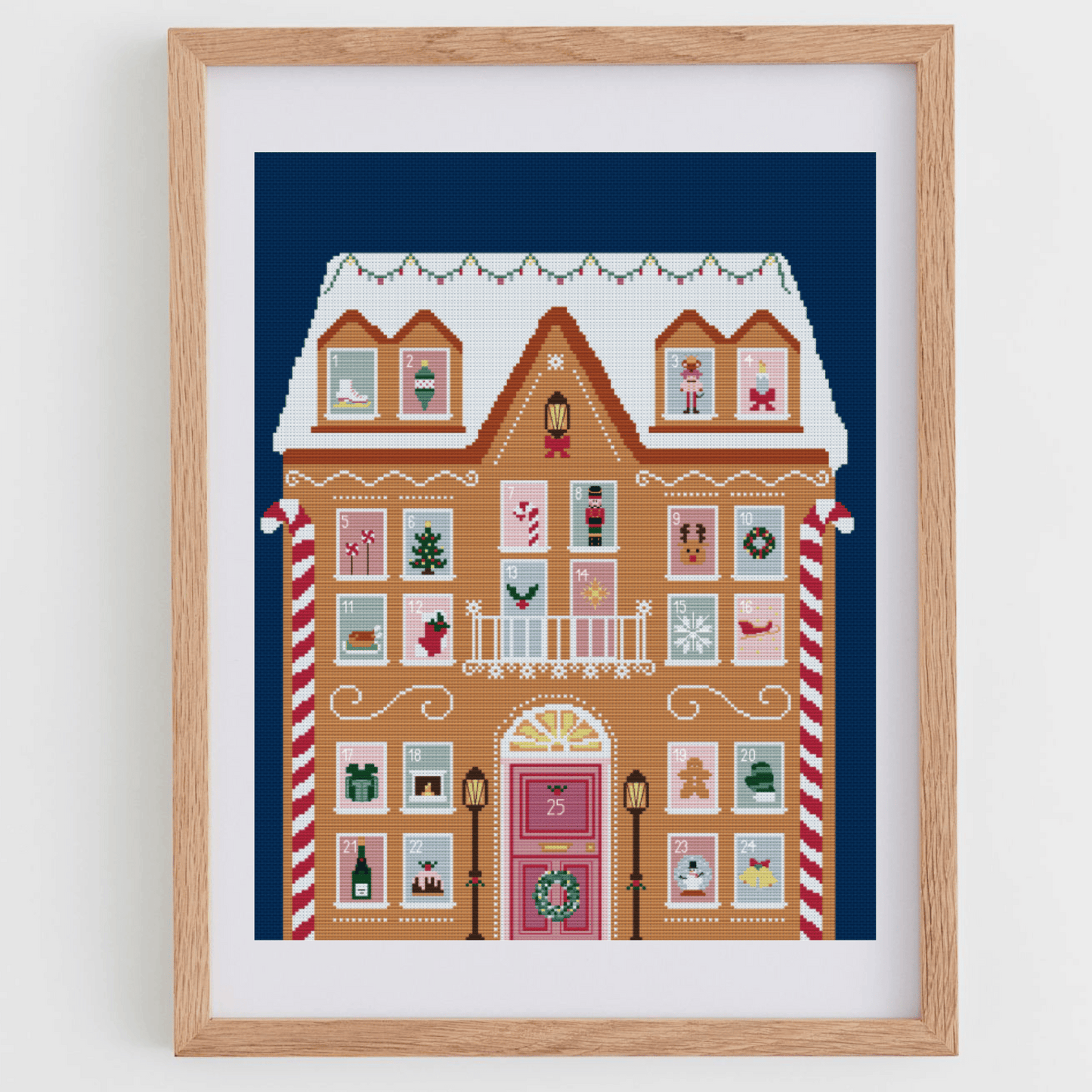 Advent calendar cross stitch pattern with a gingerbread house and different Christmas details in each window | Christmas cross stitch charts