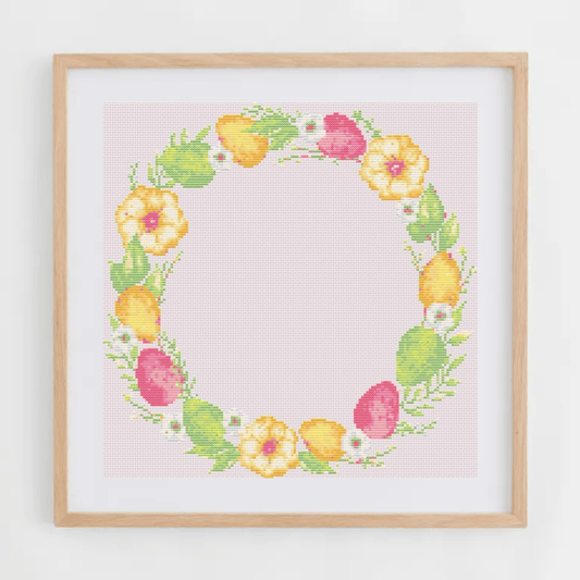 Pink Easter wreath cross-stitch pattern with a wreath made of Easter eggs and flowers | Easter cross stitch charts | Modern and pretty cross stitch ideas