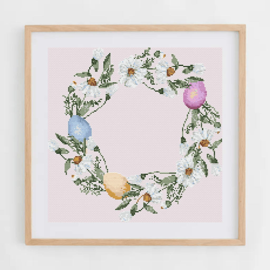 Easter wreath cross-stitch pattern with a wreath made of Easter eggs and daisies | Easter cross stitch charts | Modern and pretty cross stitch ideas