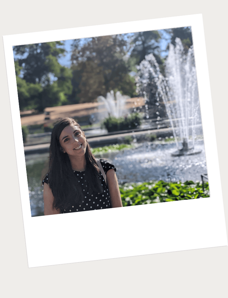 Woman standing in front of a fountain in a park