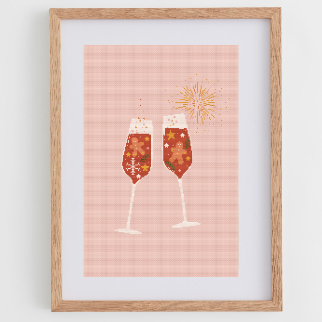 Gingerbread toast cross stitch pattern with two glasses of champagne and gingerbread cookies.
