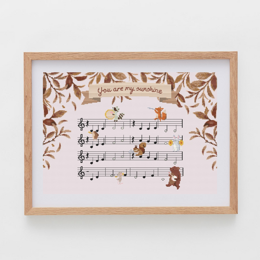 You are my sushine cross-stitch pattern, with the lullaby sheet music and forest animals playing instruments.