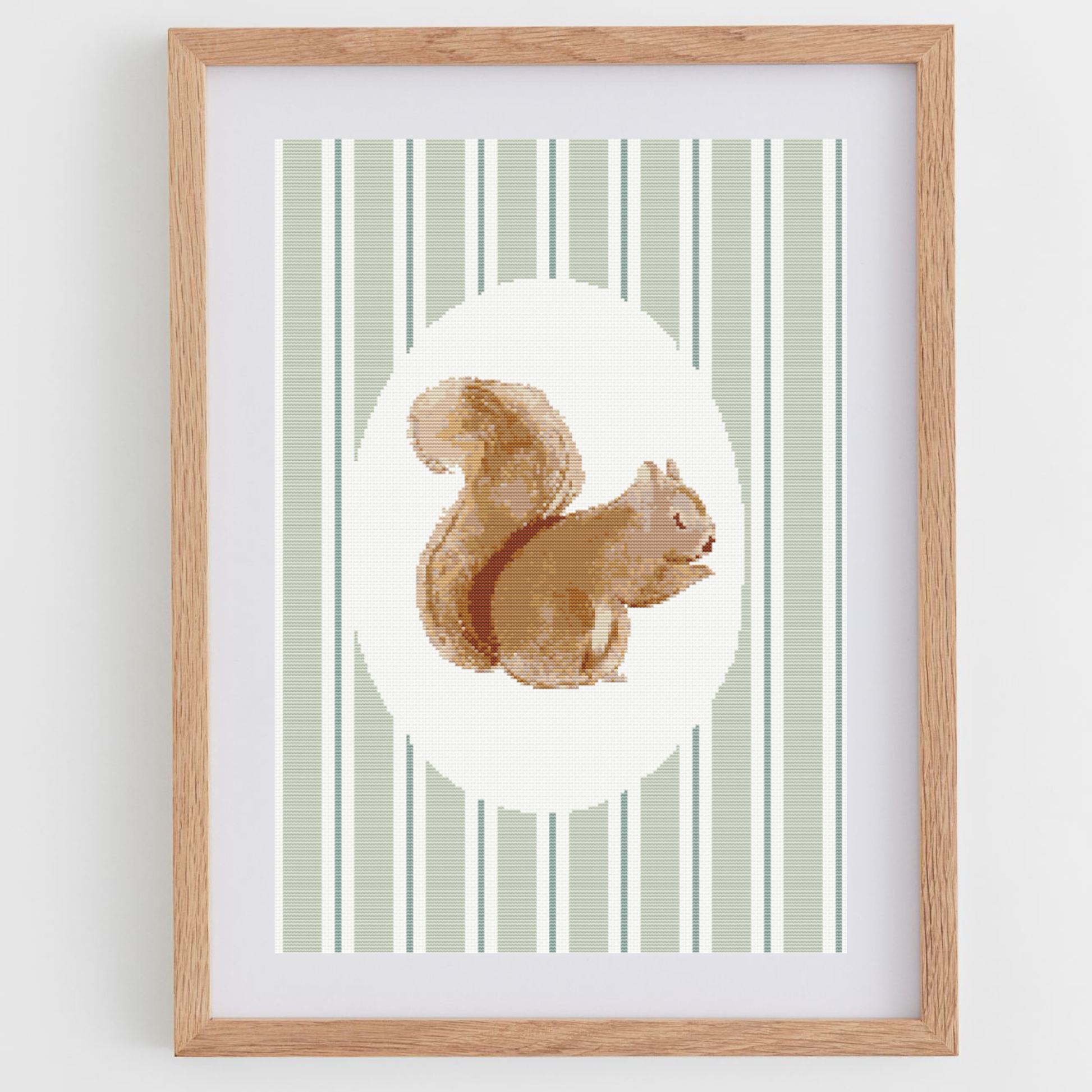 Squirrel cross-stitch pattern, in a portrait shape, perfect for a nursery or baby room.