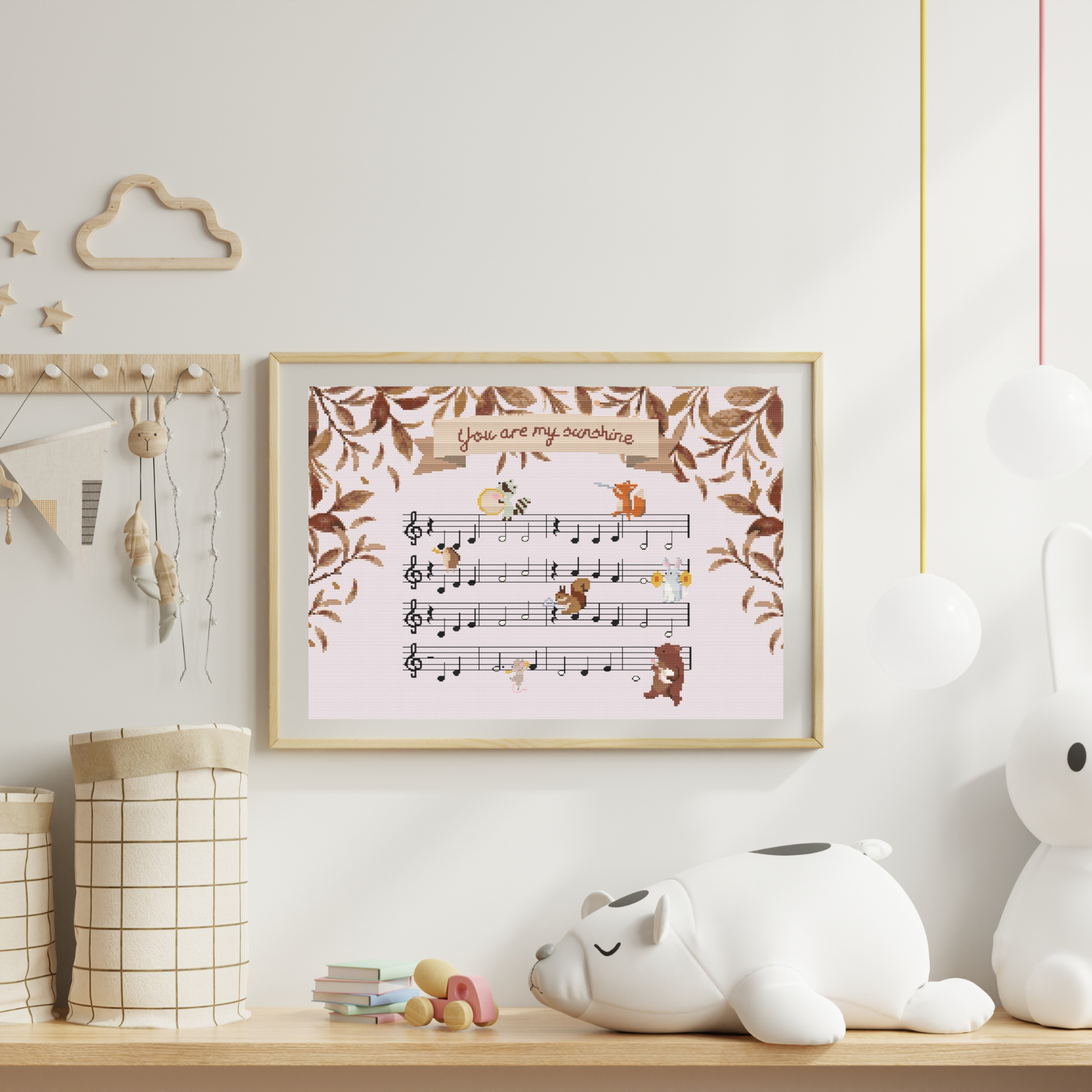 You are my sushine cross-stitch pattern, with the lullaby sheet music and forest animals playing instruments.